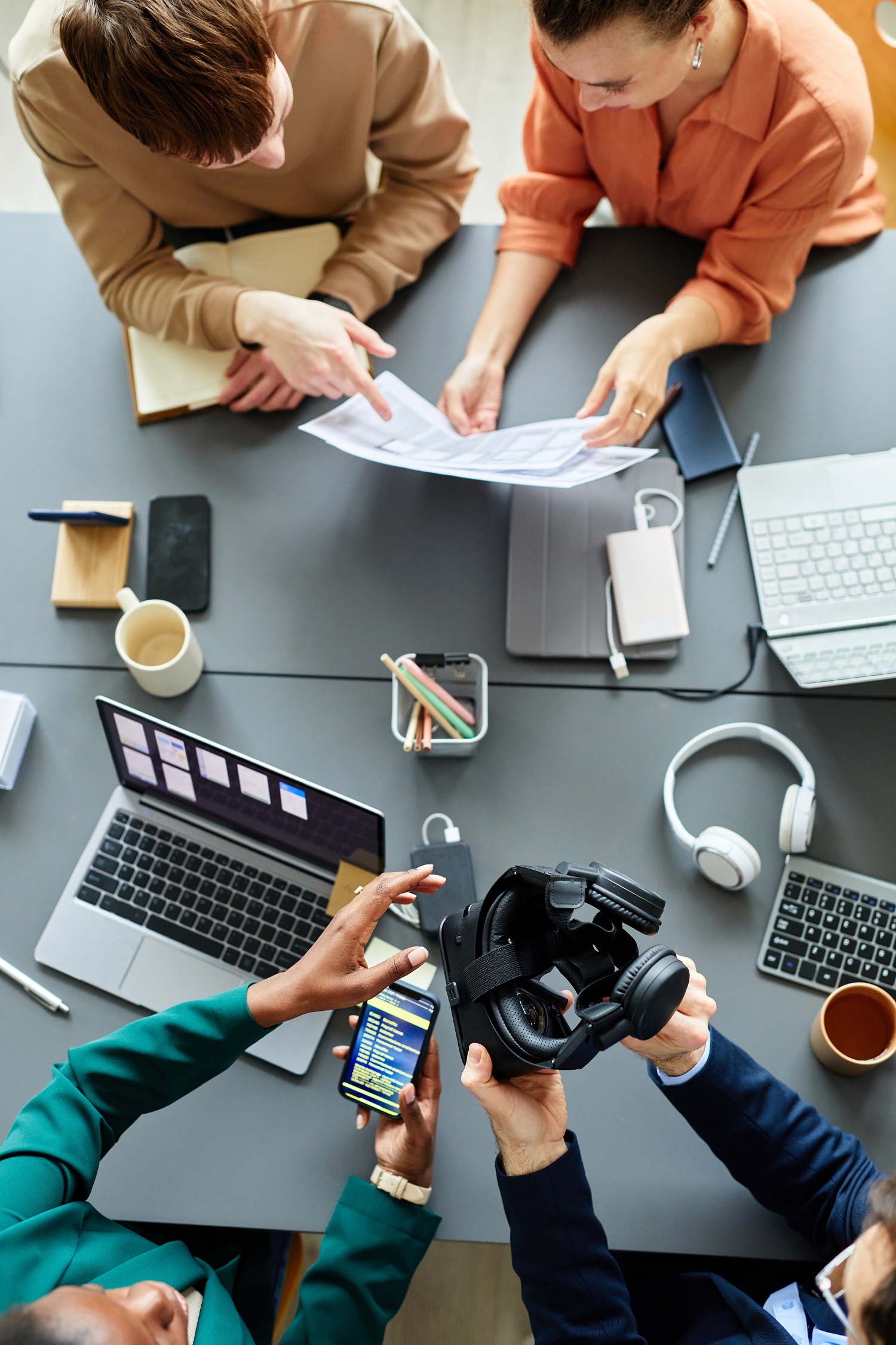 Teamwork of programmers at table at meeting